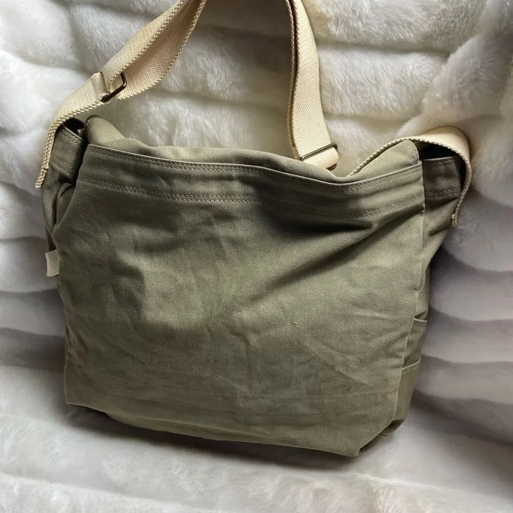 Lucky Brand large canvas olive green messenger bag with adjustable beige strap.